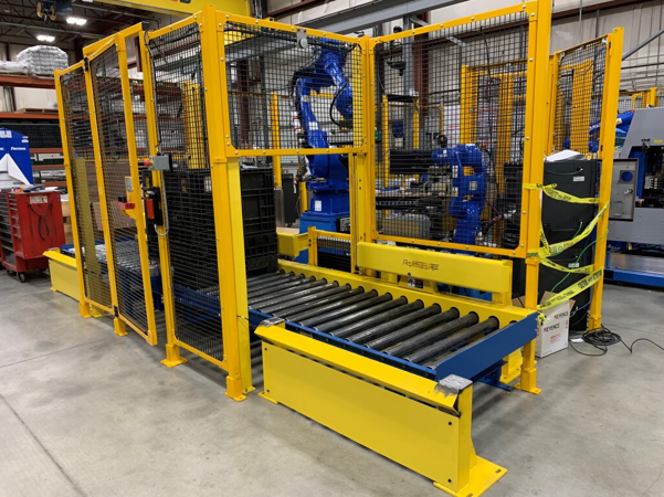 An image meant to showcase the CDLR conveyor from Rolmaster and its' use in a closed cell. This is a compact conveyor system, with space-saving conveyor design in mind.