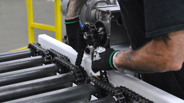 A man installing chain on a CDLR conveyor